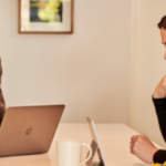 Couple talking in kitchen looking at tablet